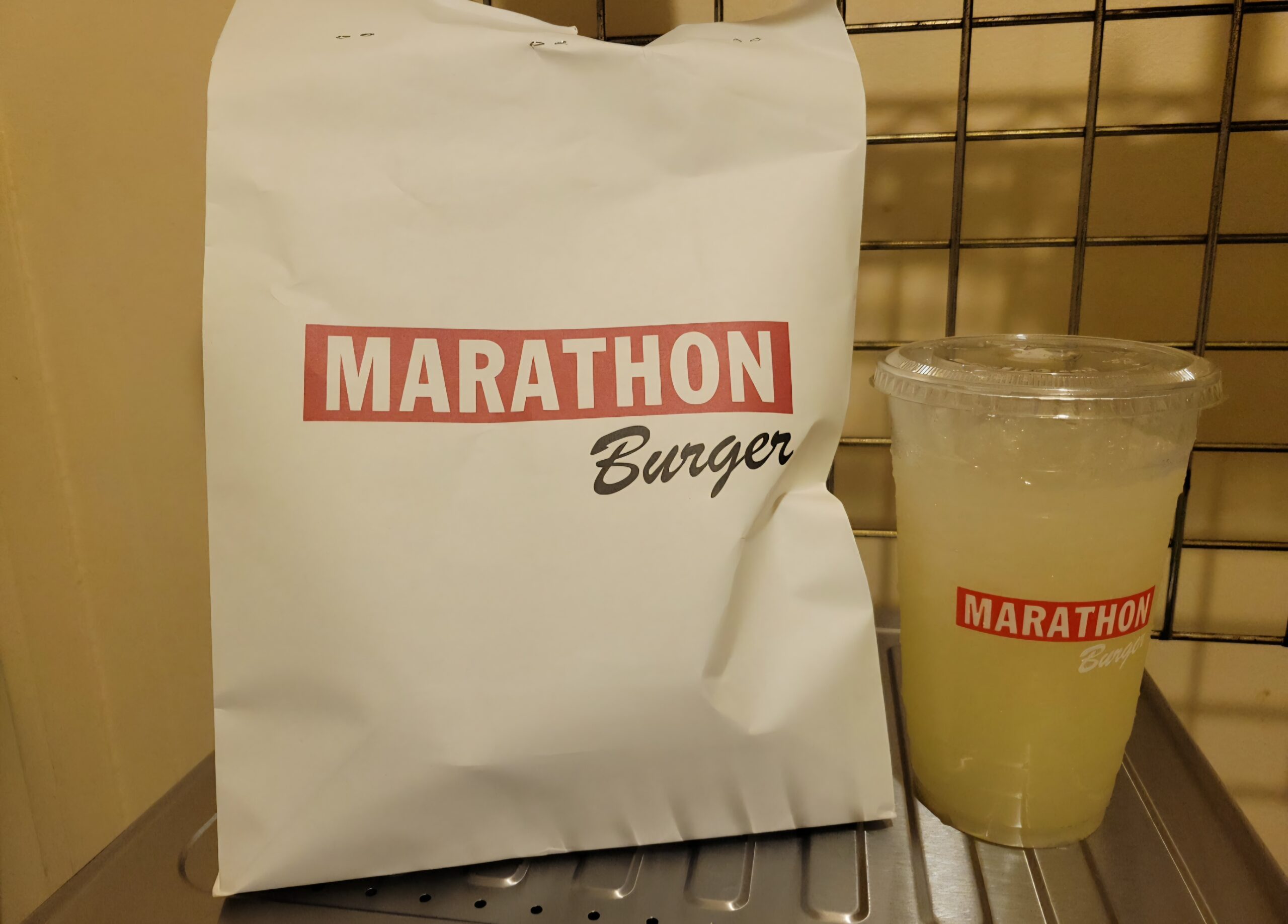 Marathon Burger takeaway bag and lemonade drink at Melrose